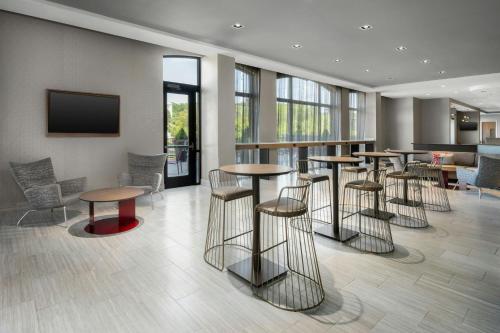 a bar with stools and tables in a lobby at Springhill Suites By Marriott Athens Downtown/University Area in Athens