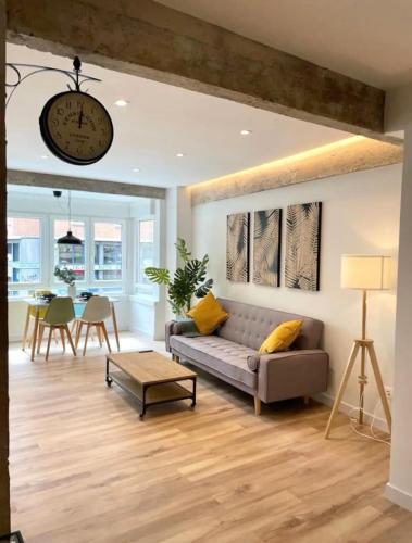 a living room with a couch and a table at Modern apartment self check in bilbao center in Bilbao