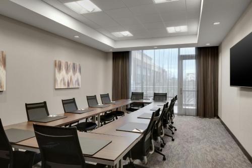 a conference room with a long table and chairs at AC Hotel Cincinnati at Liberty Center in West Chester