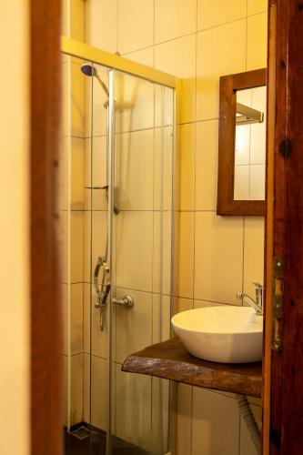 a bathroom with a sink and a shower with a mirror at Güneş Boutique Hotel - Oludeniz in Oludeniz