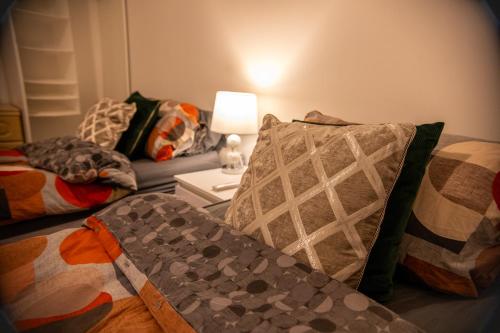 a living room with two beds and a table with a lamp at Stylish Kent apartment in Maidstone