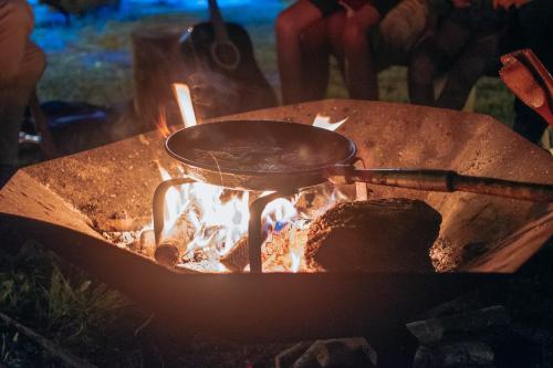 a pot sitting on top of a fire at Happy Hippy Cabin for 4 persons in Gataučiai