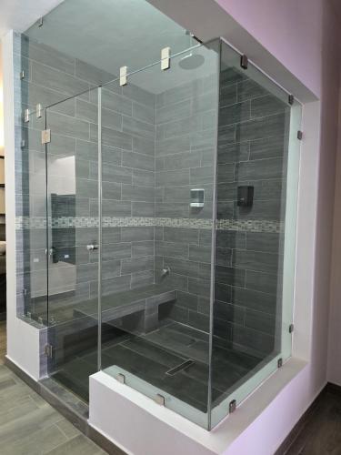 a shower with a glass door in a bathroom at Casa de Alara in Chapala