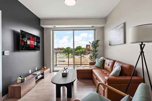 a living room with a couch and a table at W413 Stylish Luxury 1Bedroom In Downtown Minneapolis, Minutes From Minneapolis Convention Center & US Bank Arena in Minneapolis