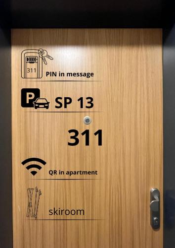 a wooden door with a sign on it at Apartmány Ski&Bike Siréna in Janske Lazne