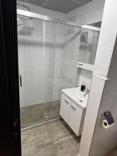 a bathroom with a glass shower and a sink at Ada Park Hotel in Kusadası