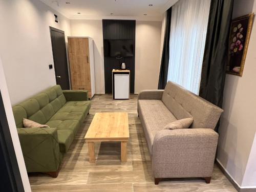 a living room with two couches and a coffee table at Ada Park Hotel in Kusadası