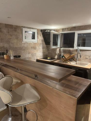 une cuisine avec un comptoir avec des chaises et un évier dans l'établissement T2 cosy à Sainte-Maxime - Confort & Tranquillité, à Sainte-Maxime