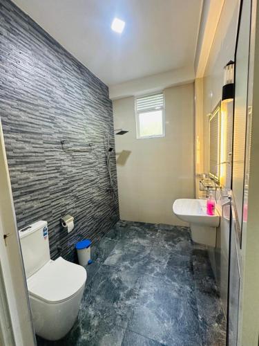 a bathroom with a toilet and a sink at Residence Inn in Udawalawe