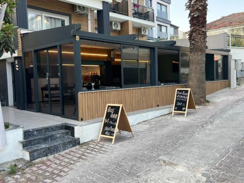 a restaurant with two signs in front of a building at Ada Park Hotel in Kusadası