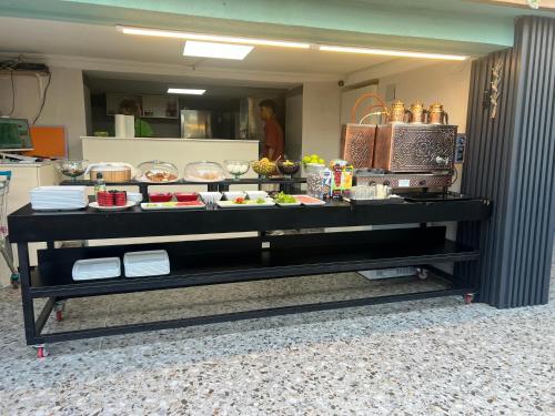 a buffet table with food on it in a kitchen at Ada Park Hotel in Kusadası