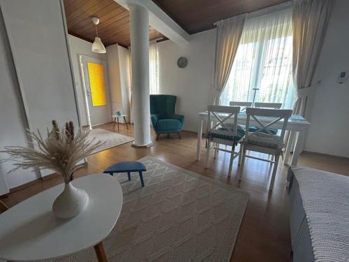 a living room with a table and a dining room at Apartment 086 in Cetinje