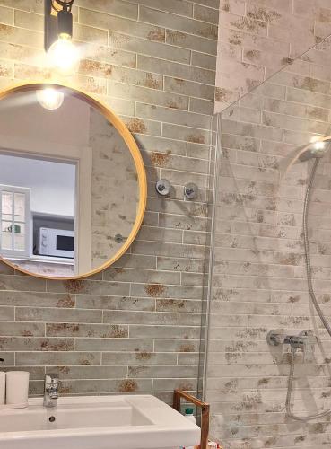 a bathroom with a mirror and a sink at Sun&Ocean in Morro del Jable