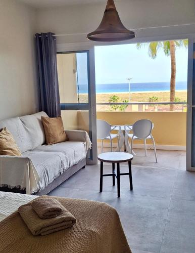 a living room with a couch and a table at Sun&Ocean in Morro del Jable