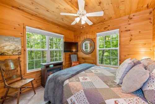 a bedroom with a bed and a ceiling fan at Serenity Escape Treehouse on 14 acres near Little River Canyon in Fort Payne