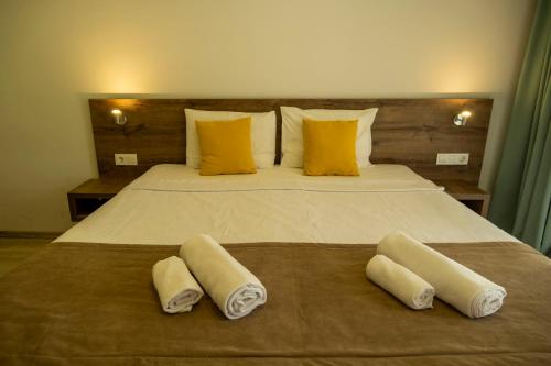 a bedroom with a bed with two towels on it at Güneş Boutique Hotel - Oludeniz in Oludeniz
