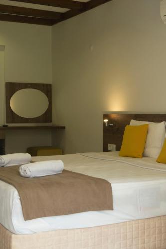 a bedroom with two beds with yellow pillows at Güneş Boutique Hotel - Oludeniz in Oludeniz