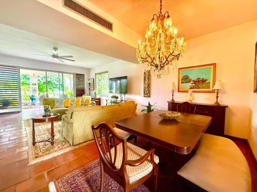 a living room with a table and a dining room at Villa Teale Serene Dorado Escape in Dorado