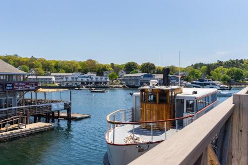 a boat is docked at a dock in the water at Fisherman's Wharf Inn in Boothbay Harbor