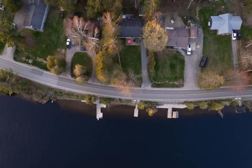 an aerial view of a road next to a lake at Santa's Village Muskoka Retreat - Waterfront Kayaks Hot Tub in Bracebridge
