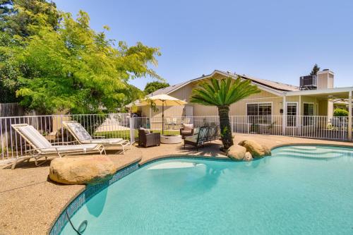 a swimming pool with two chairs and a house at Clovis Family Home Private Pool, Near Old Town! in Clovis