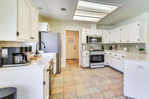 a large kitchen with white cabinets and appliances at Clovis Family Home Private Pool, Near Old Town! in Clovis