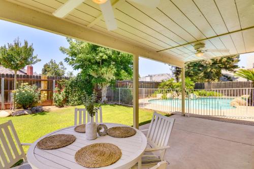 a patio with a table and chairs and a pool at Clovis Family Home Private Pool, Near Old Town! in Clovis