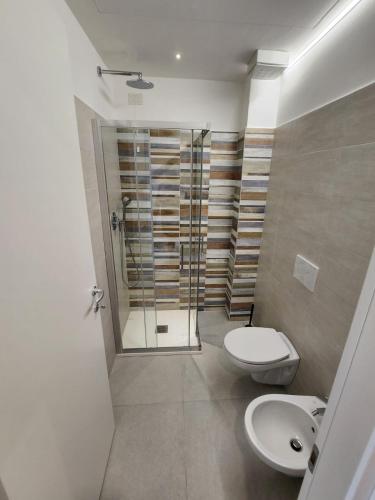 a bathroom with a shower and a toilet and a sink at TODE's Apartment in San Benedetto del Tronto