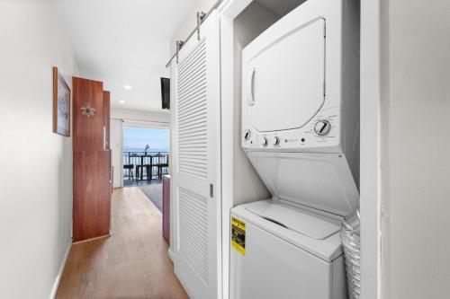 a kitchen with a washer and dryer in a room at Lahaina Roads 407 in Lahaina