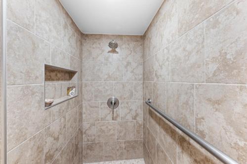 a tiled bathroom with a shower with at Lahaina Roads 407 in Lahaina