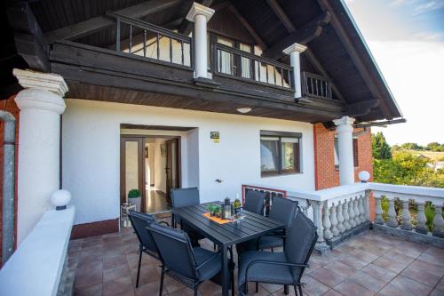 a patio with a table and chairs on a balcony at Lumaris in Ogulin