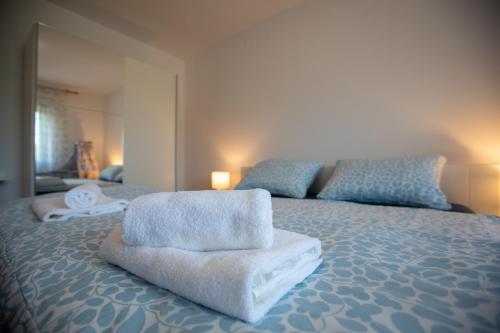 a bedroom with a bed with towels on it at Lumaris in Ogulin