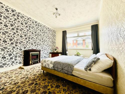 a bedroom with a bed and a fireplace at Cozy Corner Stoke in Stoke on Trent