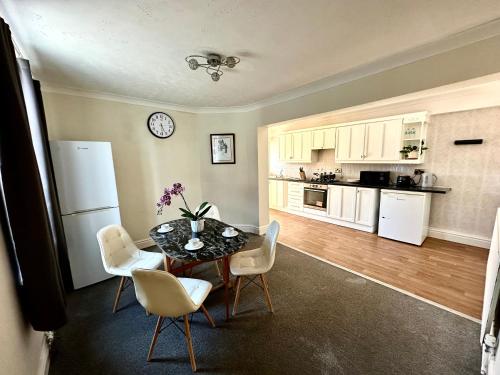 a kitchen and dining room with a table and chairs at Cozy Corner Stoke in Stoke on Trent