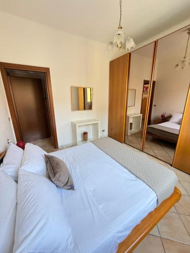 a large white bed in a room with a mirror at House near Milano in Cologno Monzese