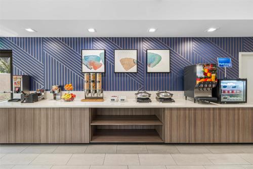 a lobby with a counter with blue and white stripes at Best Western Valencia/Six Flags Inn & Suites in Santa Clarita