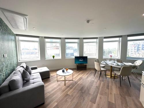 a living room with a couch and a table at Bournemouth Lookout in Bournemouth