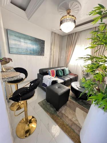 a living room with a couch and a table at Azure Villa Suites Apart Hotel in Limbe