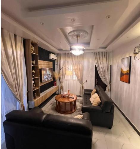 a living room with two couches and a coffee table at Azure Villa Suites Apart Hotel in Limbe