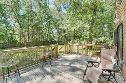 a deck with chairs and tables on a house at Walk to Fox Lake Pet-Friendly A-Frame with Fire Pit in Twin Lake