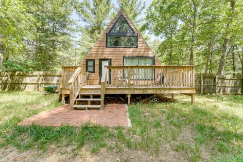 a tiny house with a porch and a deck at Walk to Fox Lake Pet-Friendly A-Frame with Fire Pit in Twin Lake