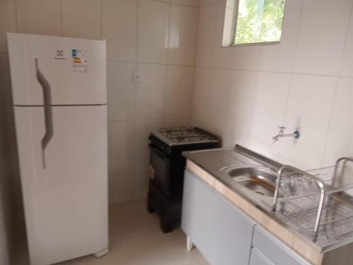 a kitchen with a stove and a refrigerator and a sink at Casa em Lavras Novas - 2 Suítes casal - AP02 in Ouro Preto