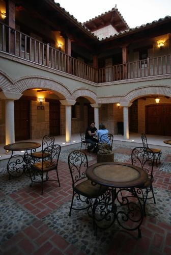 a group of tables and chairs in a courtyard at Posada Los Condestables Hotel & Spa in Villalpando
