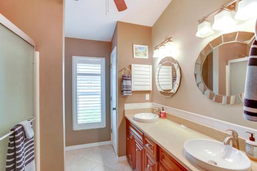 a bathroom with a sink and a mirror at 5 Mi to Fort Myers Beach Home with Heated Pool! in Fort Myers