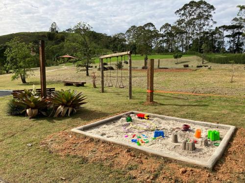 a sandbox filled with sand in a park at Chácara da Mantiqueira - São Francisco Xavier in São José dos Campos