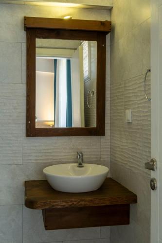 a white sink in a bathroom with a mirror at Güneş Boutique Hotel - Oludeniz in Oludeniz