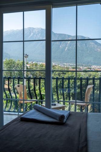 a room with a table with a view of a mountain at Güneş Boutique Hotel - Oludeniz in Oludeniz