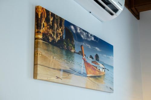 a picture of a boat hanging on a wall at Güneş Boutique Hotel - Oludeniz in Oludeniz