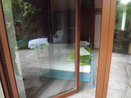 a glass door with a reflection of a bed outside at 10 os - Gdansk-Sopot-Gdynia up to 19 persons in Gdynia