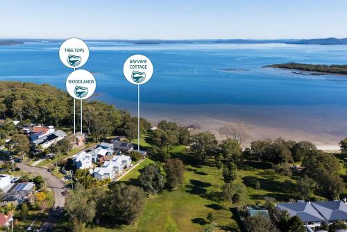 an aerial view of a house with three large signs at Woodlands Water Front Soldiers Point- Ground Floor in Soldiers Point